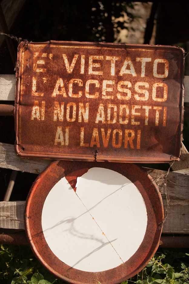 A rusty, old sign on an abandoned building in San Pietro in Valle