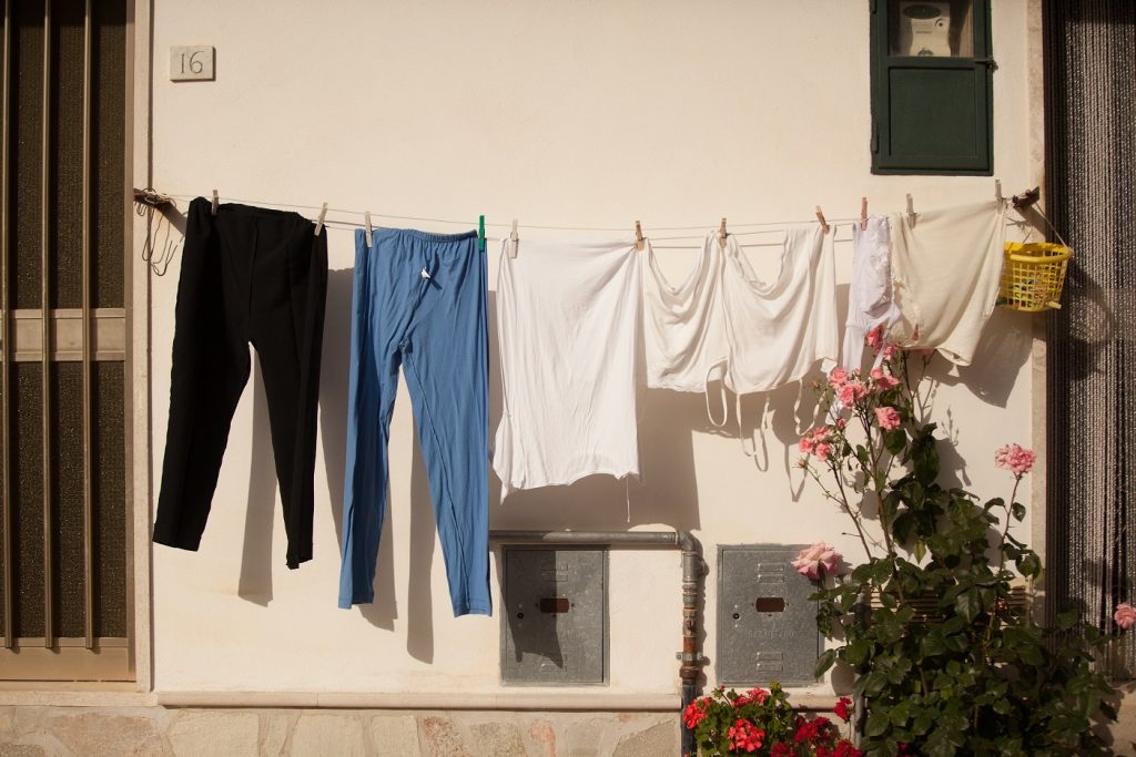 Clothes hang on a line suspended between two doorways in San Pietro in Valle.