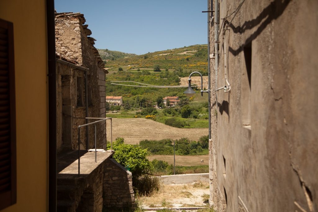 A view between buildings in Frosolone showing the rolling hills of Molise